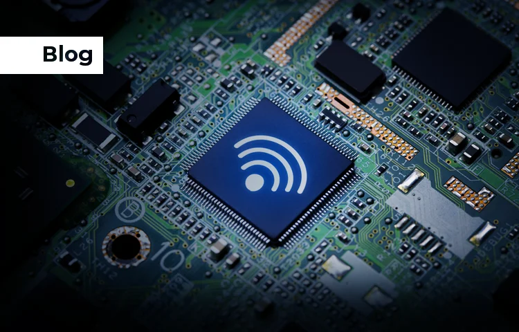 Close-up of a circuit board with a central chip displaying a WiFi symbol, surrounded by other electronic components.
